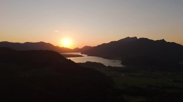 Beautiful sunset Over Lake Wolfgangsee and the municipality Strobl in Austria.