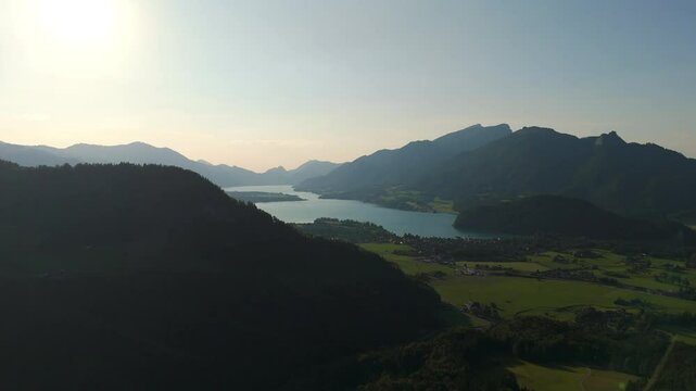 Aerial: Lake Wolfgang and Strobl am Wolfgangsee in the Salzburg Alps region in the late afternoon in Austria, pan drone shot