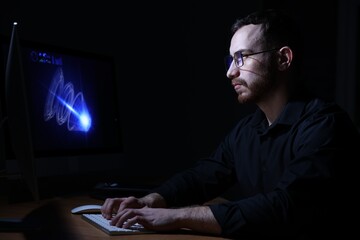 Engineer working with digital drawing at table in office
