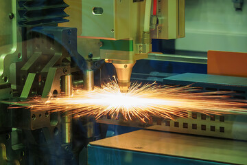 Close up scene the fiber laser cutting machine cut the metal plate control by CNC program.