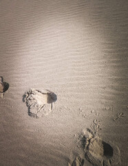 Step prints on sand.
