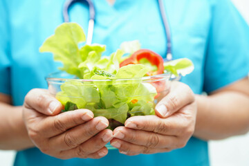 Asian Nutritionist holding healthy food for patient in hospital, nutrition and vitamin.