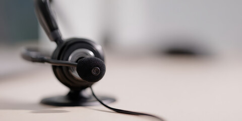 Close up of black headset with microphone on desk