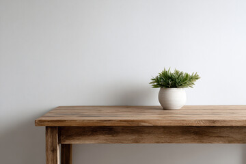 Wooden table with potted plant on minimalist background