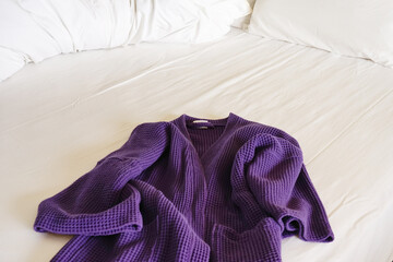 white bed with Purple bathrobe