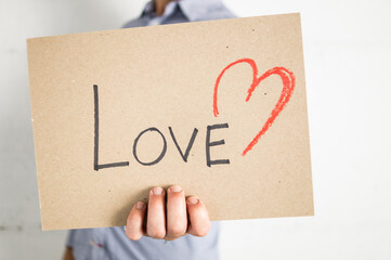 Unrecognizable person holding a love sign in his hand