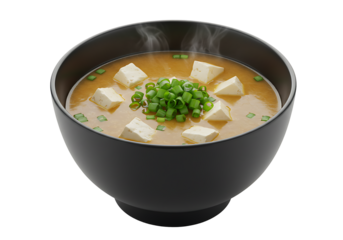Miso soup in a black bowl topped with tofu cubes and chopped green onions against a black background Steam rises from the soup