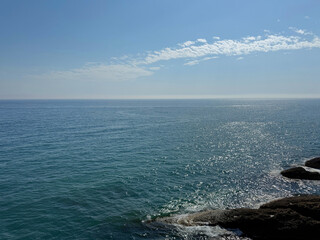 Blue shiny sea, clear sky and rocky Mediterranean coast.