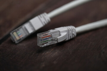 ethernet internet cat6 lan white cable close up shot on dark theme background 