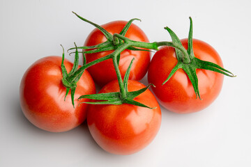 Fresh ripe tomatoes on vine isolated on white background