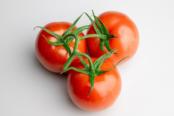 Fresh ripe tomatoes on vine isolated on white background