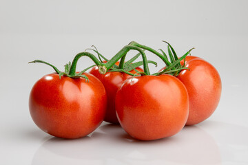 Fresh ripe tomatoes on vine isolated on white background