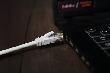 ethernet internet cat6 lan white cable close up shot on dark theme background 