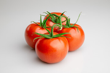 Fresh ripe tomatoes on vine isolated on white background