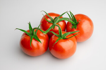 Fresh ripe tomatoes on vine isolated on white background