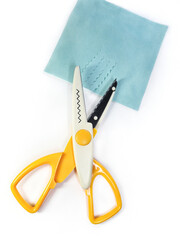 Zigzag wavy pattern scissors on a white background. Yellow creative scissors with serrated blades for decorative cutting. Scissors for crafts, card making, scrapbooking and other DIY projects.