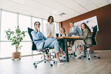 Young professionals collaborating in a modern office environment, fostering teamwork, creativity,...
