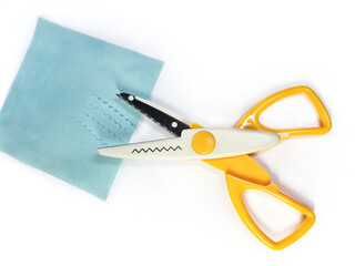 Zigzag wavy pattern scissors on a white background. Yellow creative scissors with serrated blades for decorative cutting. Scissors for crafts, card making, scrapbooking and other DIY projects.