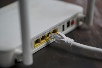 ethernet internet cat6 lan white cable close up shot on dark theme background 