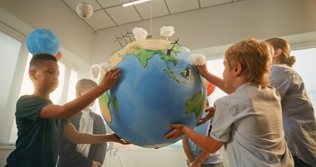 Science Lesson: Female Teacher Educating Renewable Energy to Smart Kids in Multiethnic Classroom....