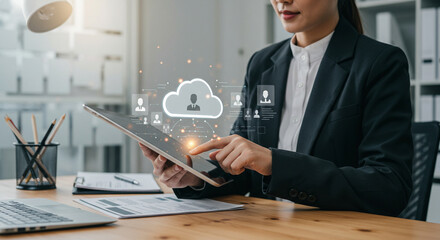 A person in a professional setting operates a tablet with a virtual interface for people and business data.