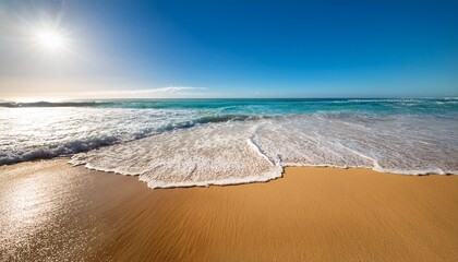 golden sand stretches along a vibrant beach under a clear blue sky waves crash gently on the shore as the scorching sun beats down typical of a summer heatwave