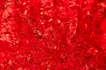 Bright red crumpled foil texture creating a vibrant abstract background for creative projects