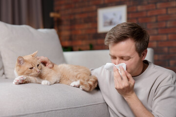 Man suffering from allergy with his cat at home