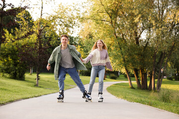 Happy couple roller skating together in park