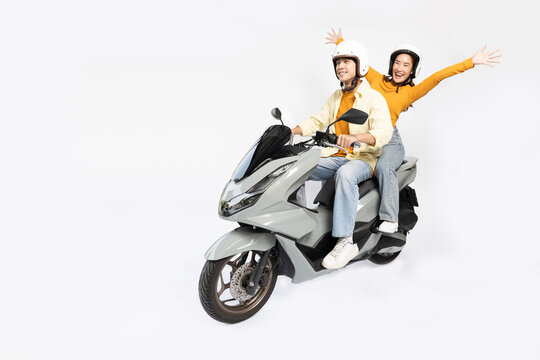 Happy Asian man and Asian woman riding motorcycle isolated over white background, Asia Couple concept