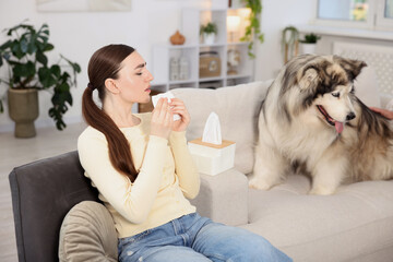 Woman suffering from allergy with her dog at home