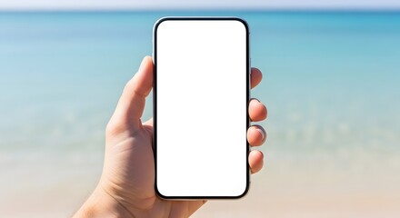 Hand holding a mockup smartphone with a blank screen on a sunny beach scene.