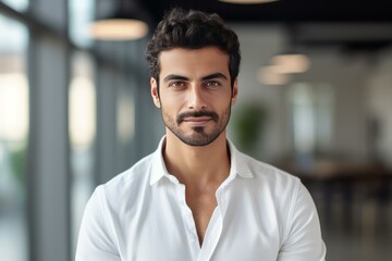 Obraz premium Portrait of a businessman standing in a modern office environment, conveying professionalism and success