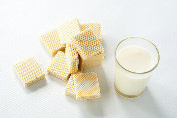 
Slice of fluffy cake and cool iced tea on a sunlit table, with a blurred person in the background. Perfect for cafe or sweet dessert themes