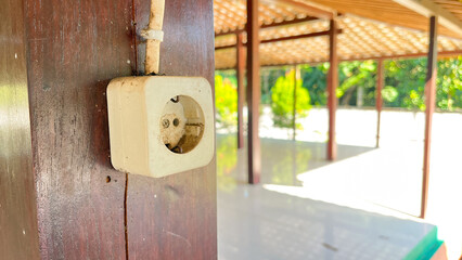 socket mounted on a wooden pillar