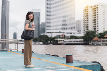 Happy southeast asian woman teenager blogger express joy during solo world travel tourism Bangkok...