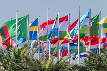 Many world's countries national flags waving on th e wind
