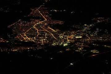 City lights at night seen from airplane window during flight
