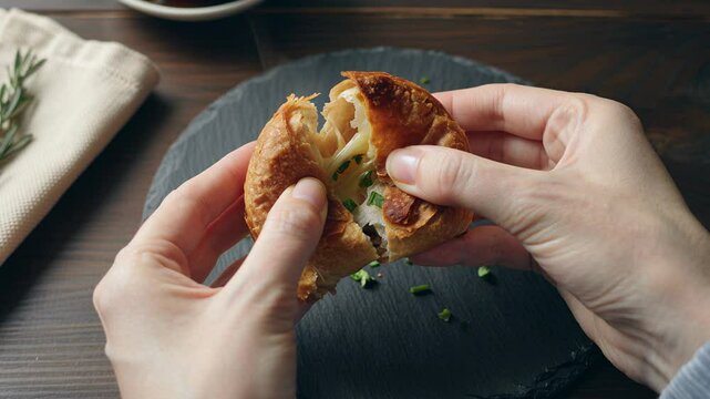 Slow motion garlic croissant tear with steam and melted butter

