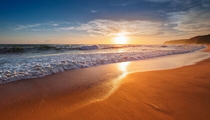 golden sand beach at sunset tranquil ocean waves gently lapping the shore empty beach coast orange