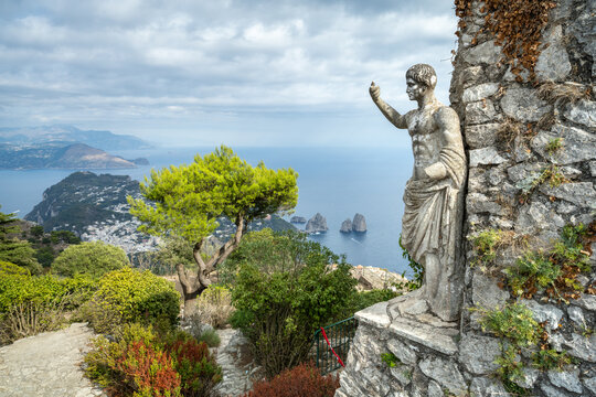 Statue of Emperor Augustus on Monte Solaro with Faraglioni rocks in the distance, Capri, Campania, Italy