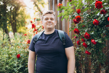 Young happy smiling man walk in green city park outdoors on nature. Urban lifestyle leisure concept. High quality photo.