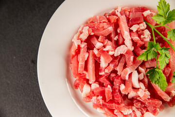 Bacon cubes smoked chopped meat small pieces fresh delicious gourmet food background on table rustic food top view copy space