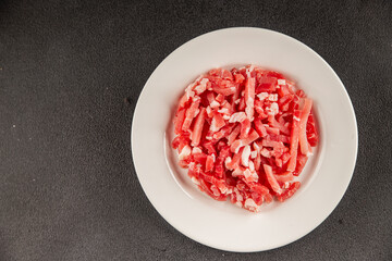 Bacon cubes smoked chopped meat small pieces fresh delicious gourmet food background on table rustic food top view copy space