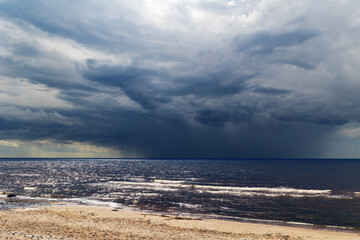 A large thundercloud looms on the horizon before a storm over the Baltic Sea in Jurmala, Latvia
