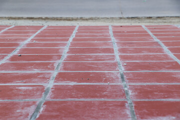 Red floor tiles laid neatly on ground, used for smooth flooring surface
