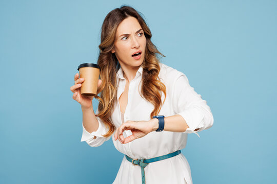 Young employee business woman corporate lawyer in shirt classic formal clothes work in office use smart watch drink coffee hurry up be in rush isolated on pastel light blue background studio portrait.