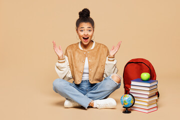 Full length young shocked surprised smart girl student wear casual clothes backpack bag sit near...