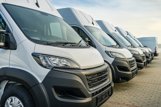 Commercial delivery vans parking in a row, transporting and shipping service company