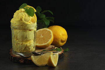 Lemon ice cream scoops in glass jar